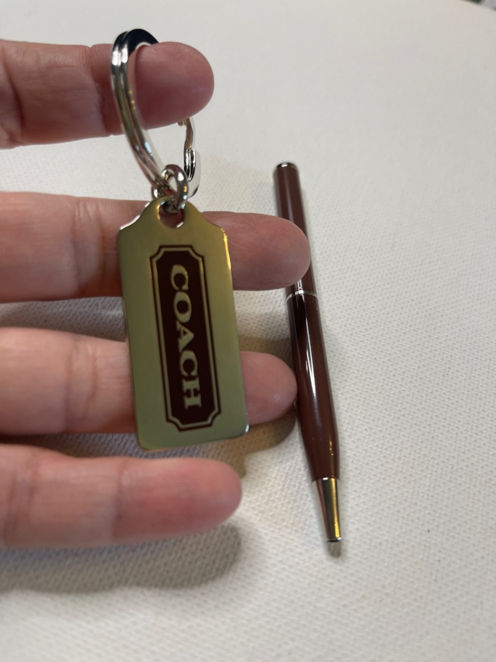 Coach Silver Key Tag with a Dark Brown Logo Panel and Dark Brown Coach Pen